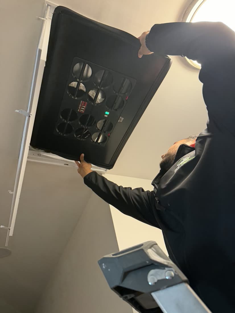 Ben measuring register airflow with a capture hood