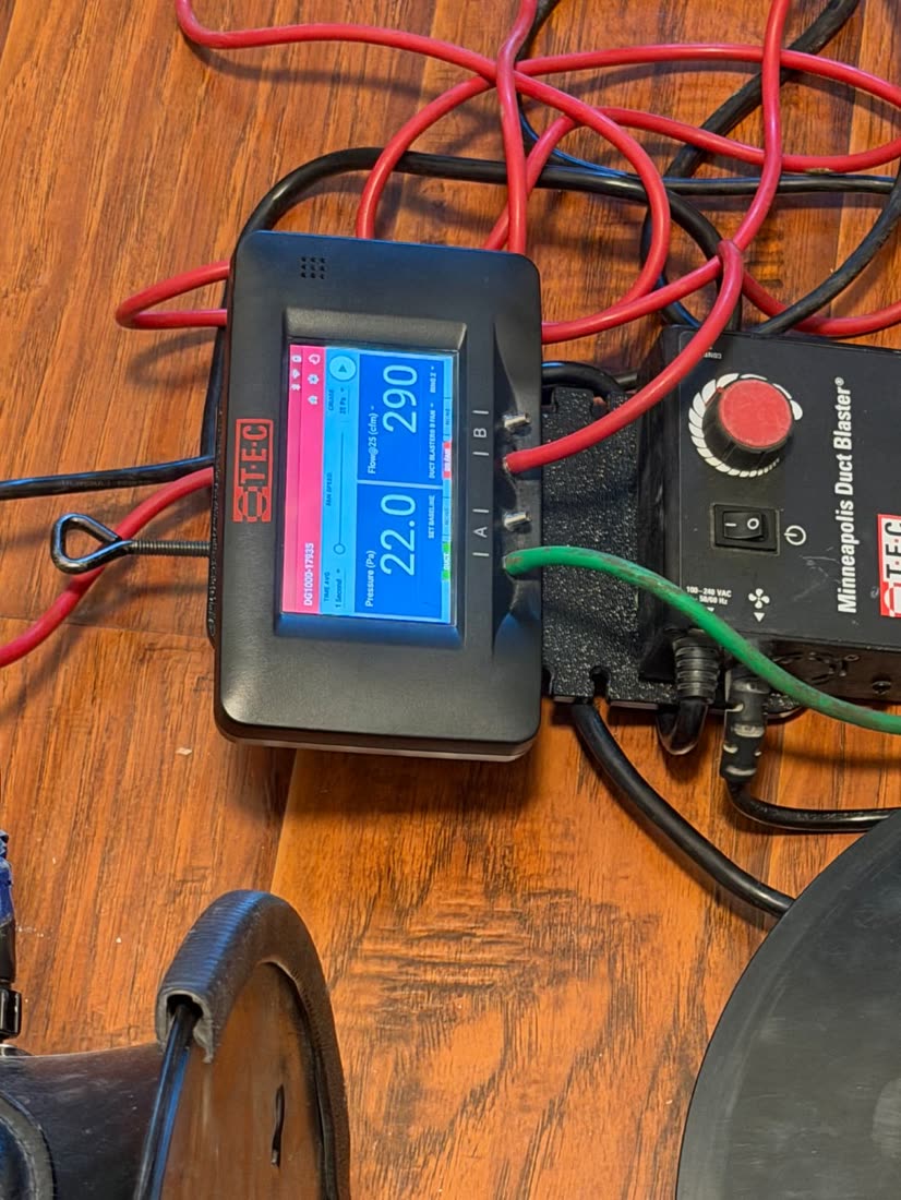 Duct leakage gauge on a hardwood floor reading 290 CFM