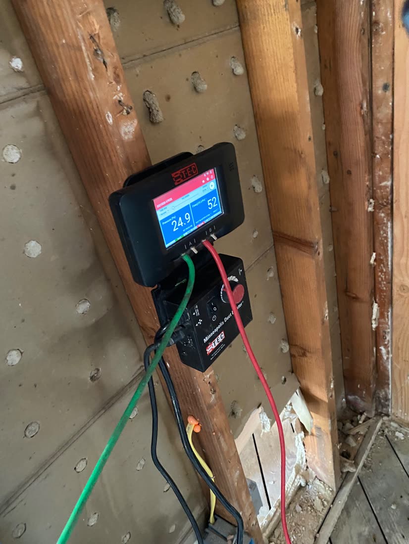 DG-1000 gauge hung on a stud reading 24.9 Pa and 52 CFM during a rough duct test