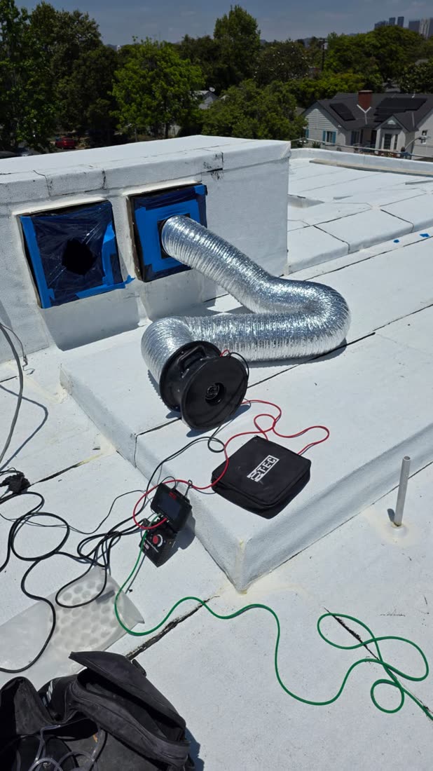 Duct Blaster on a flat commercial roof with the LA skyline behind