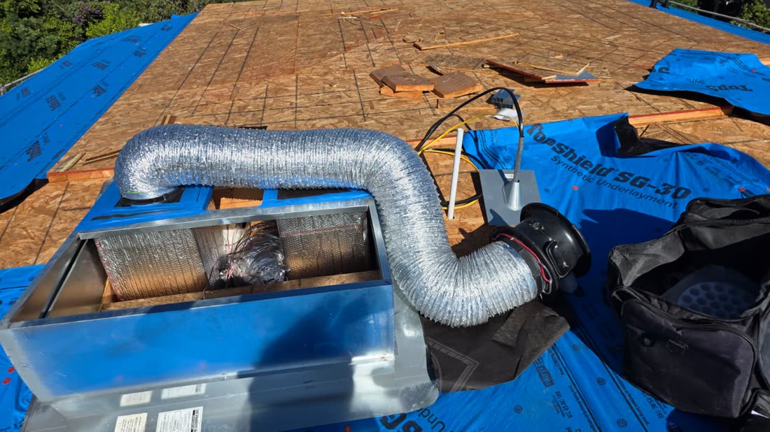 Duct Blaster connected to a register on a new-construction roof